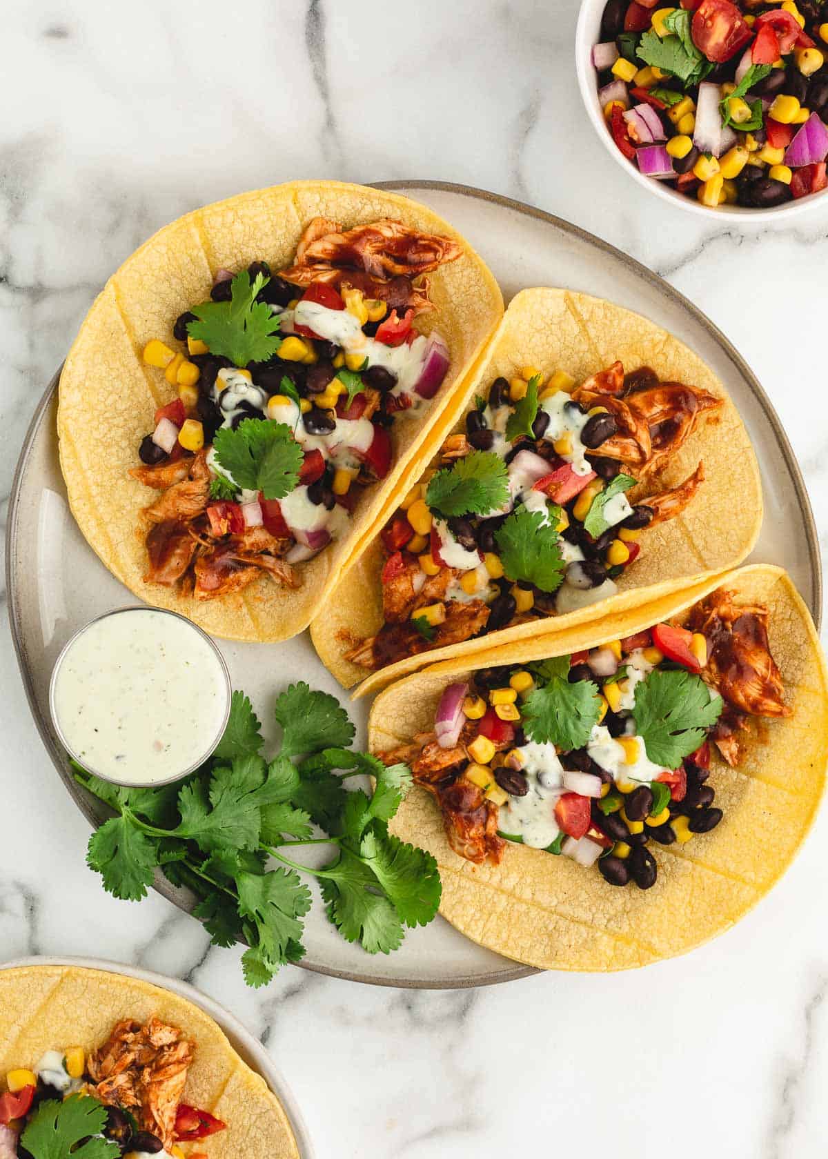 Bbq chicken tacos on plate.