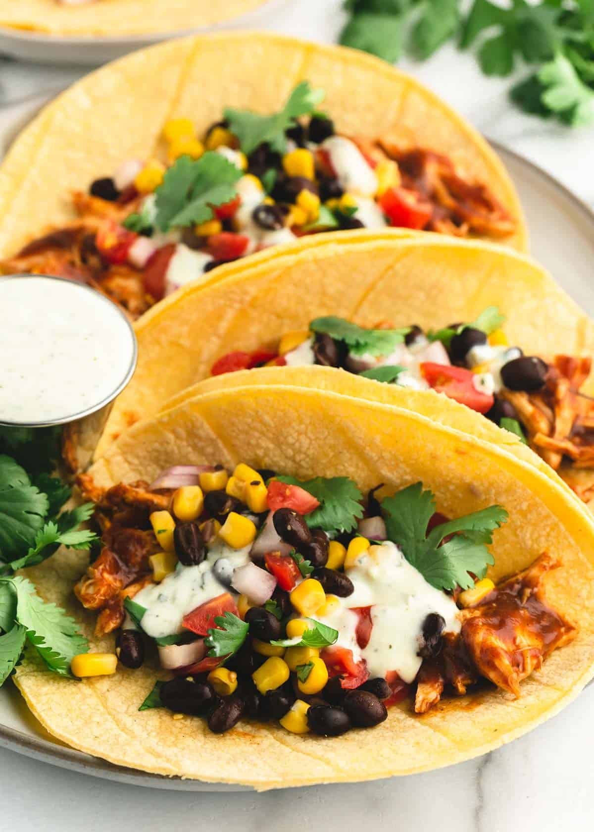 Bbq chicken tacos on plate.