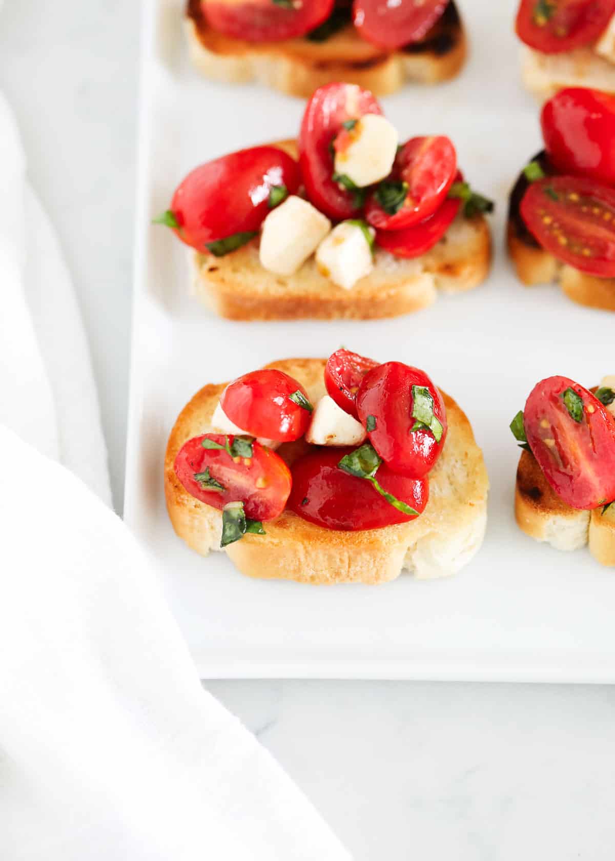 Caprese bruschetta on plate.