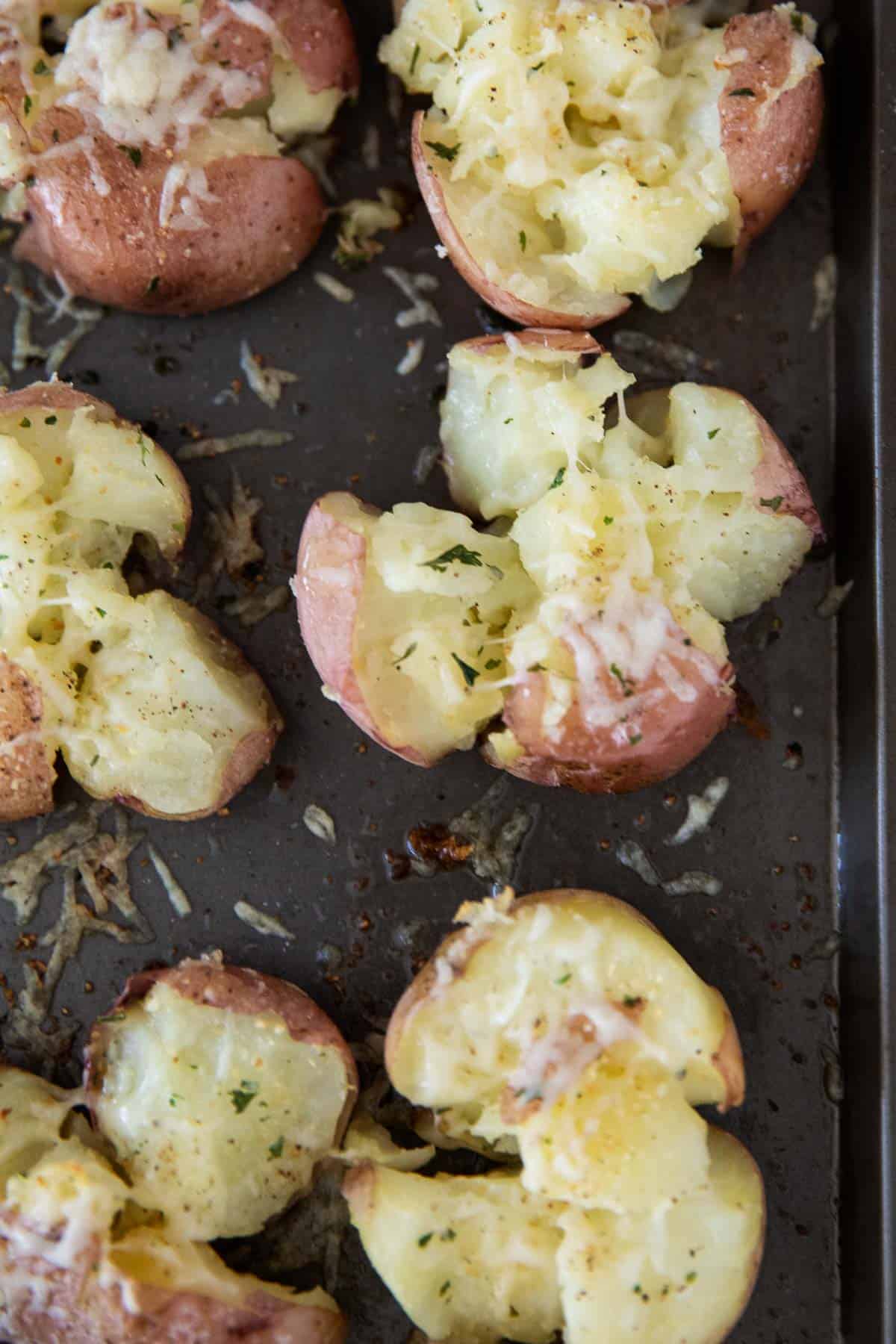 Smashed potatoes on pan.