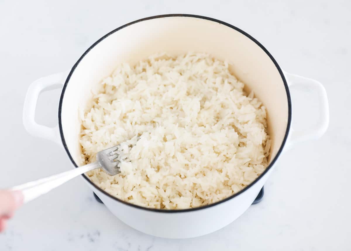 Cooked coconut rice in white pot.