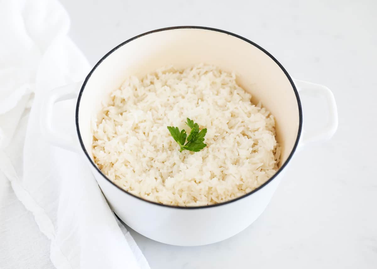 Cooked coconut rice in white pot.