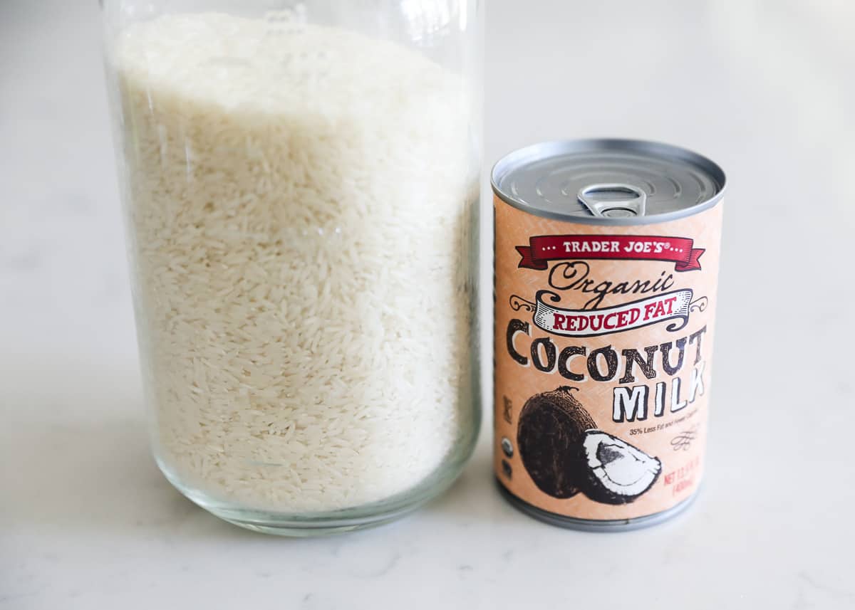 Rice and coconut milk on table.