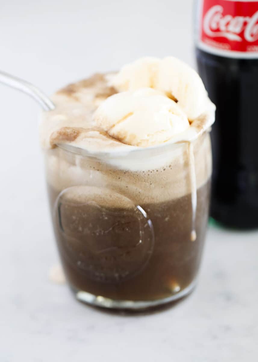 coca cola float in glass with straw 