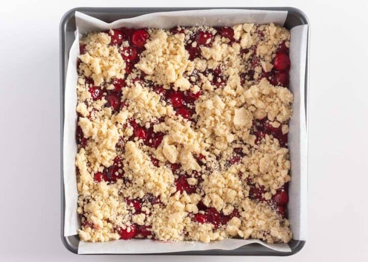 cherry pie bars with crumble topping in pan