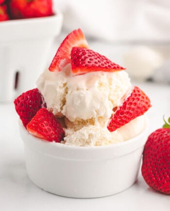 ice cream and strawberries in white bowl