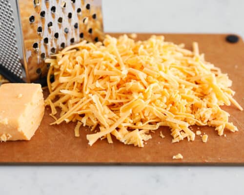 grated cheese on cutting board