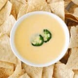 nacho cheese dip in bowl and chips