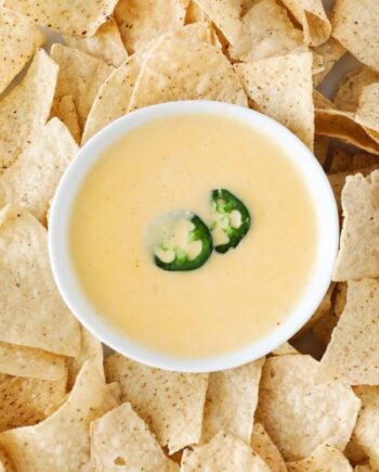 nacho cheese dip in bowl and chips