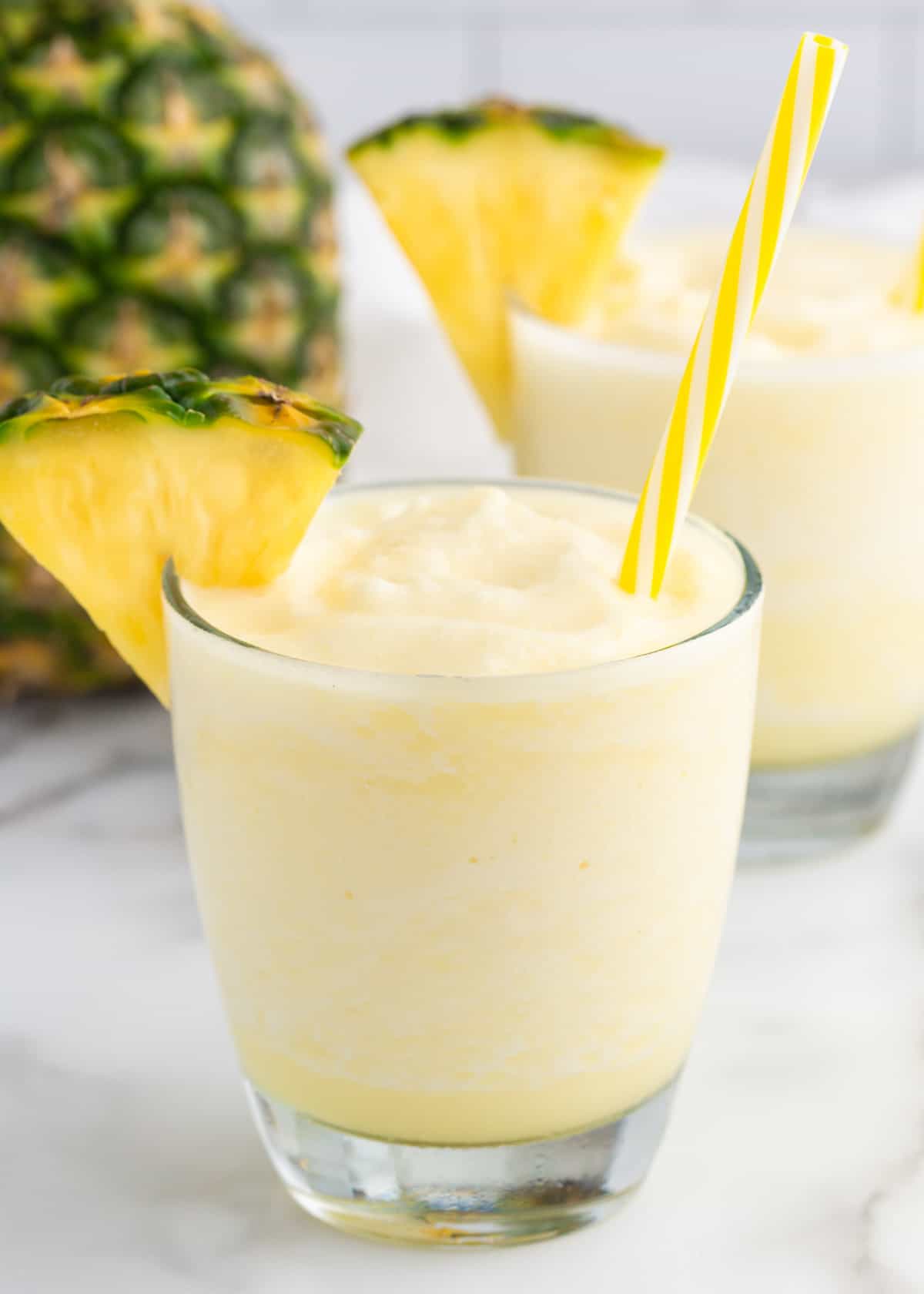 Pina colada smoothie in clear glasses.