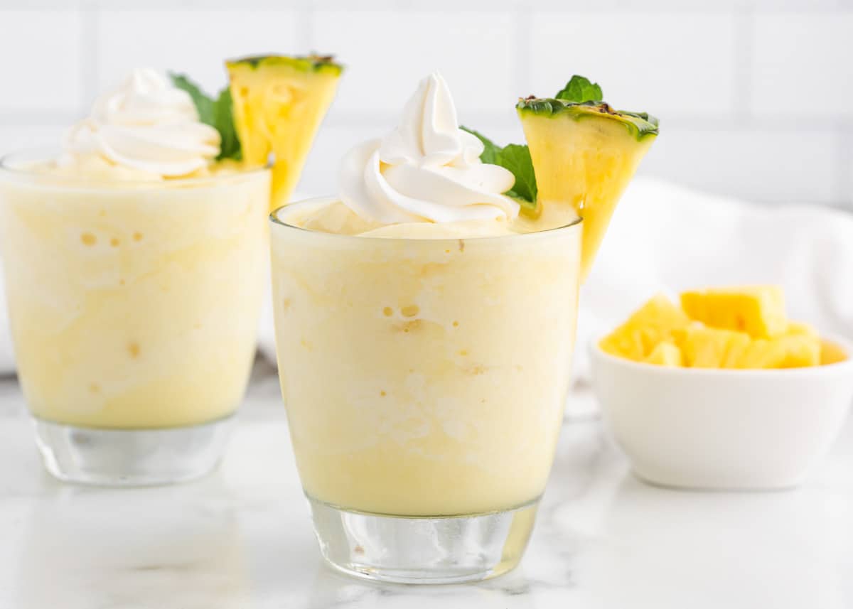 Pina colada smoothie in glass cup.