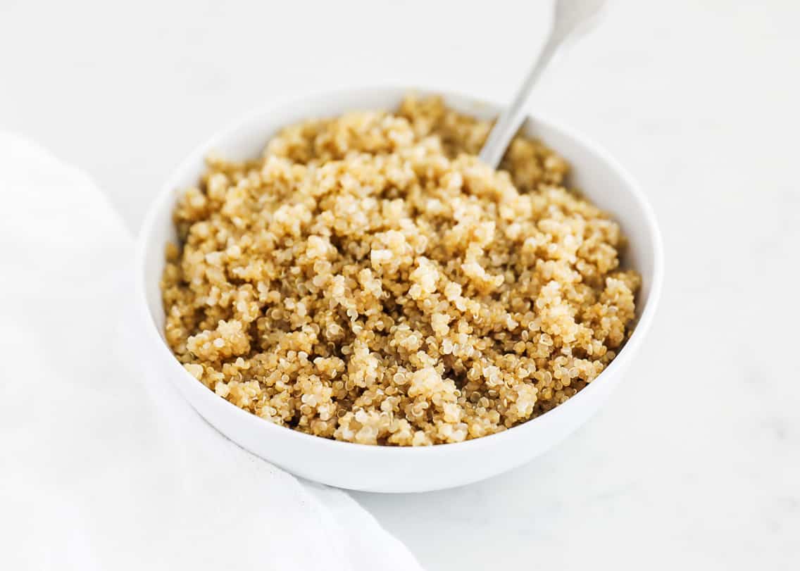 Cooked quinoa in white bowl.