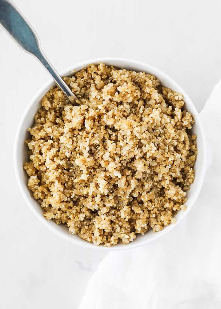 Cooked quinoa in white bowl.