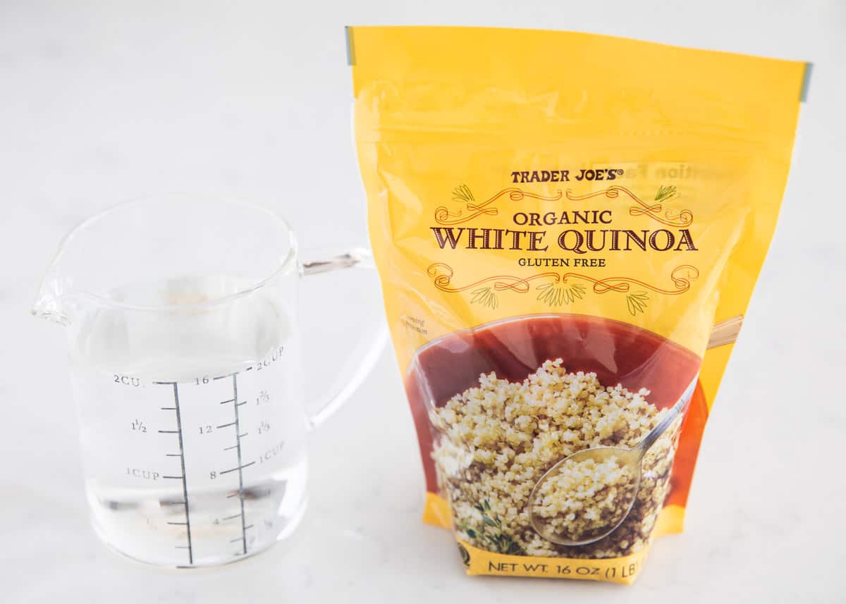 Quinoa and water on table.