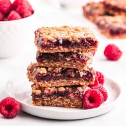 raspberry crumb bars on white plate