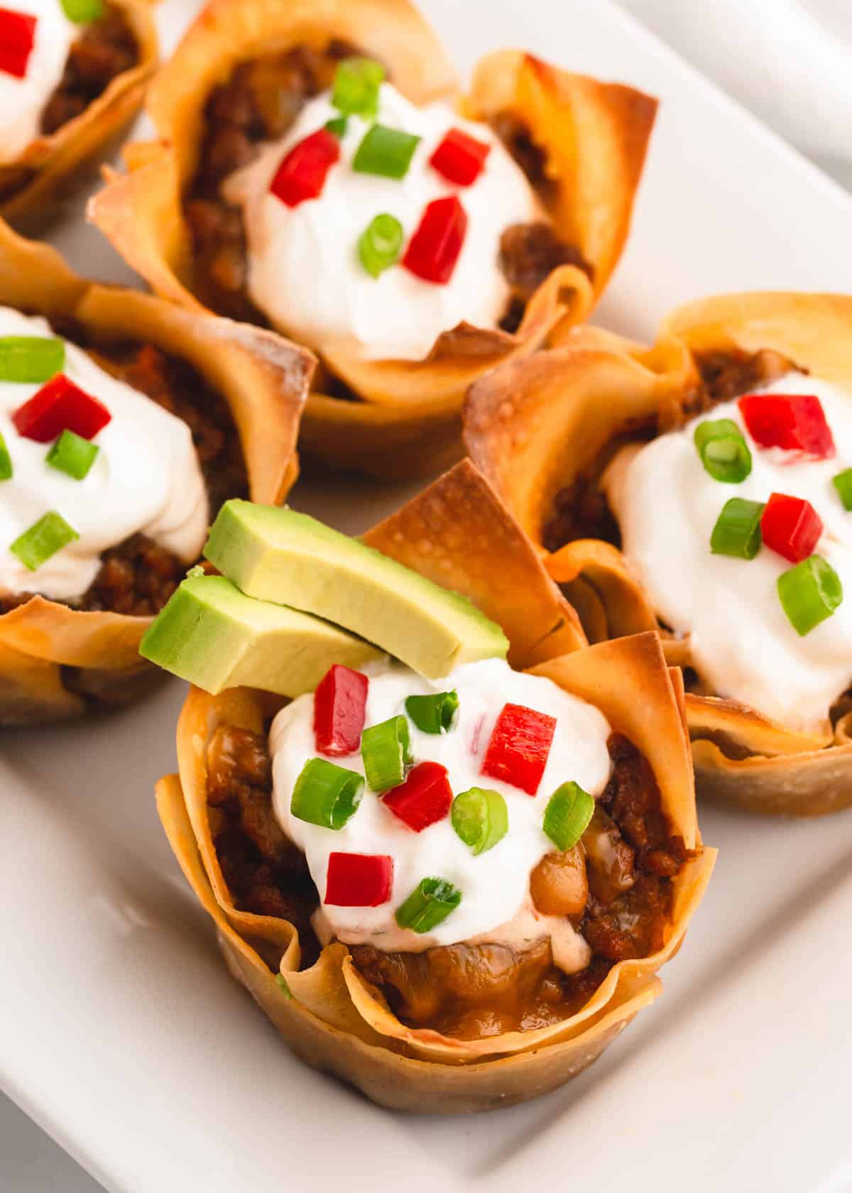 Taco cups on white plate.