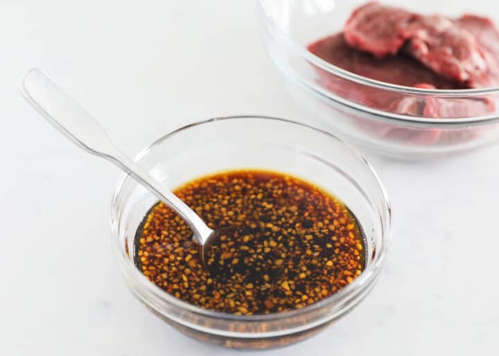 This easy teriyaki steak marinade gets penetrating flavor into every bite of meat making it tender and juicy! This simple recipe can also be used for other types of meat and seafood as well! teriyaki steak marinade in clear bowl