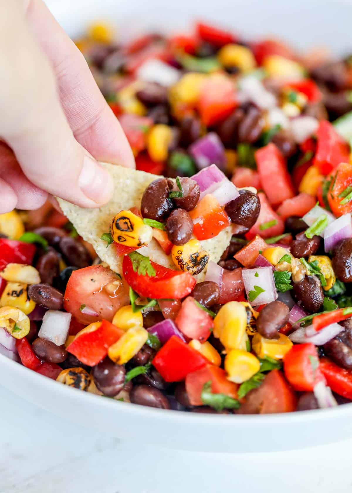 Dipping chip in black bean salsa.