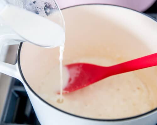 pouring milk into white pot