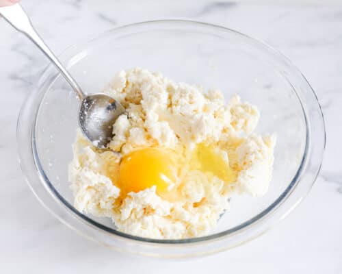 Mixing ricotta and egg in bowl