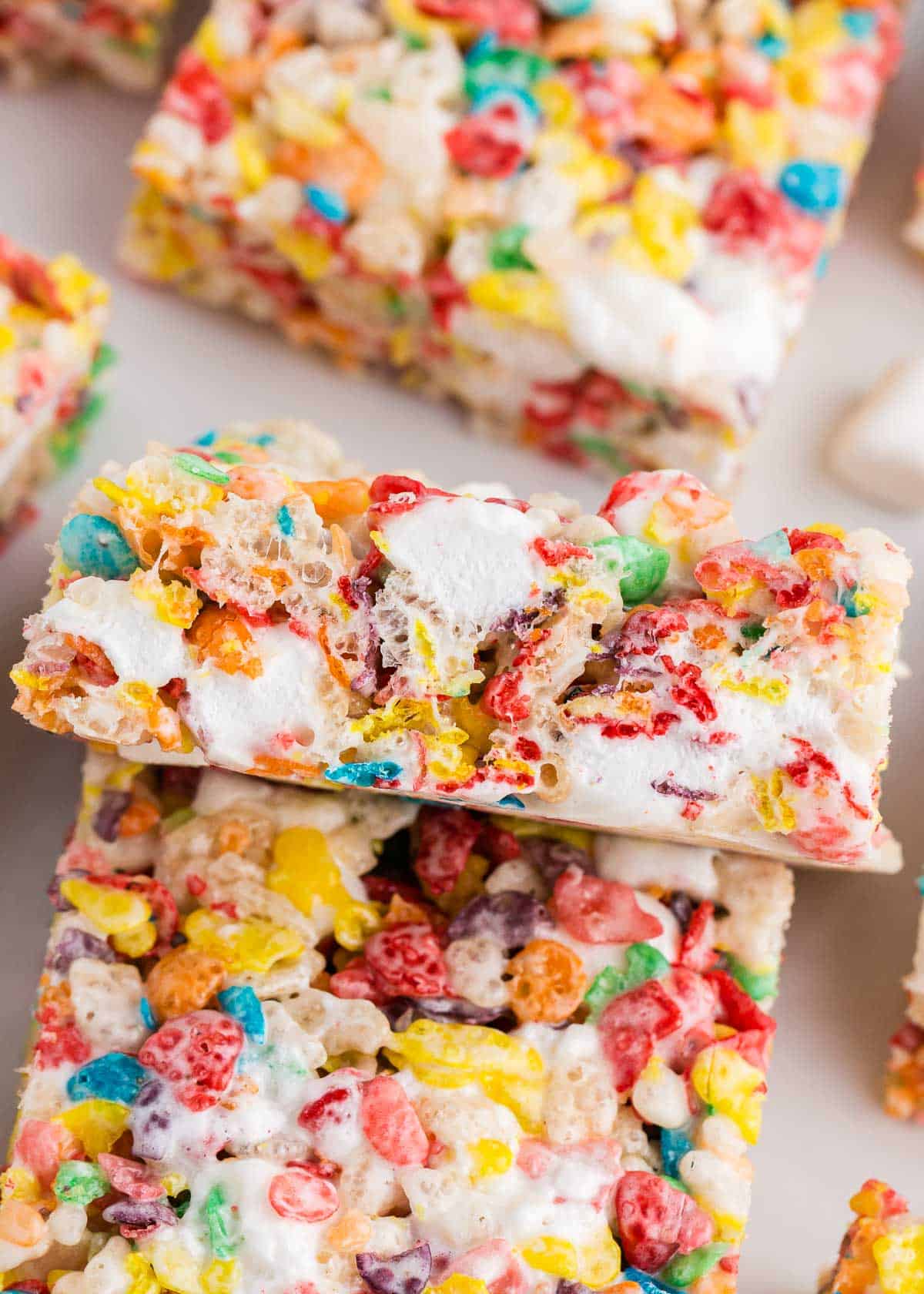 Close up of sliced fruity pebbles treats on counter.
