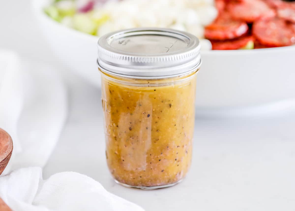 Jar of Italian dressing on counter.