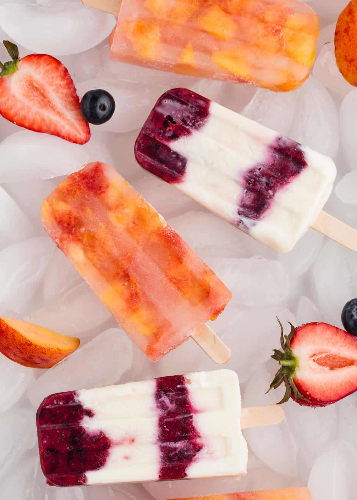 Popsicles on ice with fresh fruit.