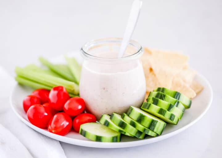 Salsa ranch dressing is a combination of two of your favorite Tex Mex flavors in one! A 5-minute cool, creamy, and zesty dressing that comes together with just salsa, ranch, and a couple of extra layers of zing! salsa ranch on white plate
