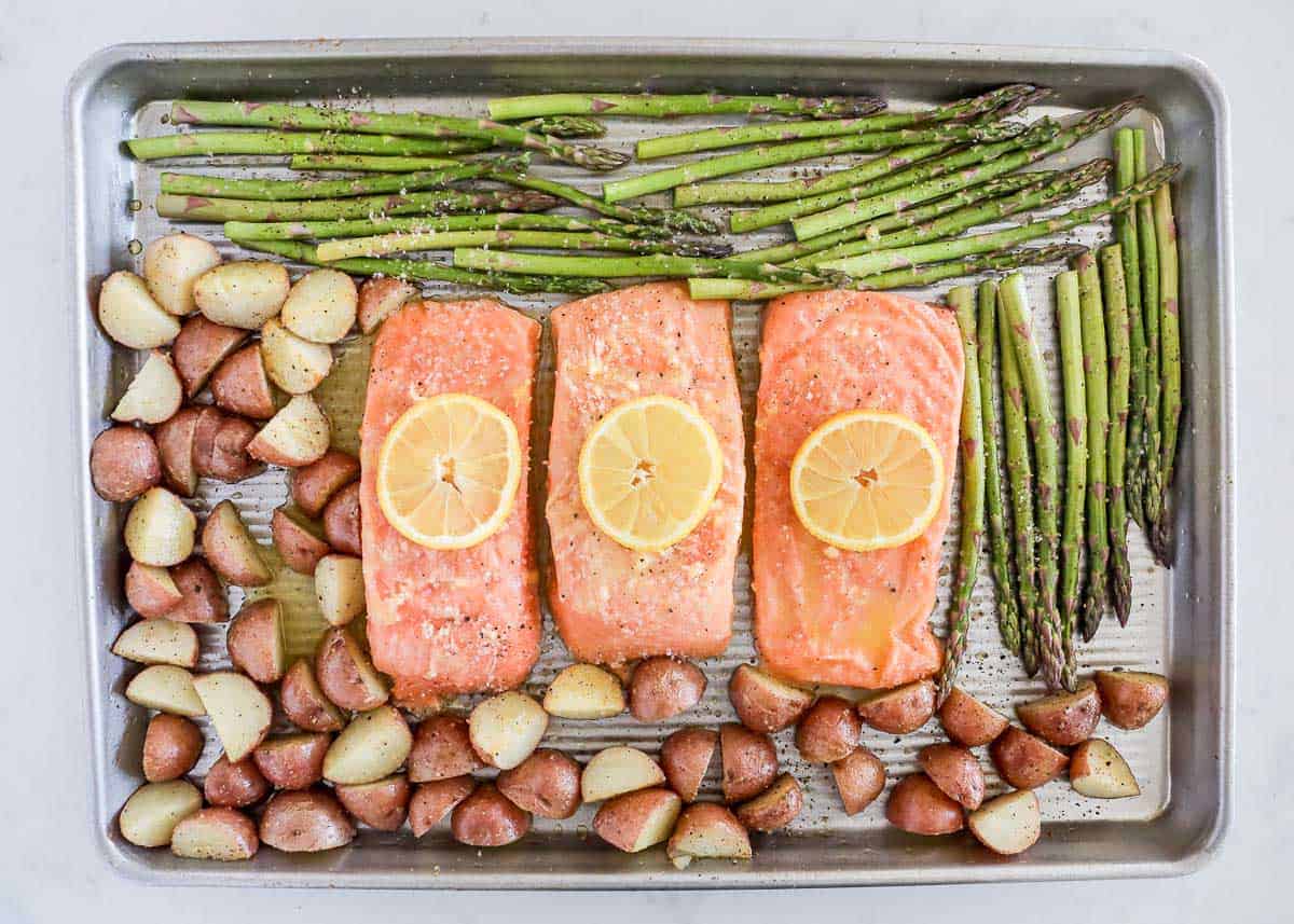 Salmon, potatoes and asparagus on pan.