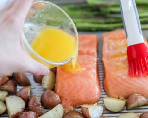 pouring butter sauce over salmon