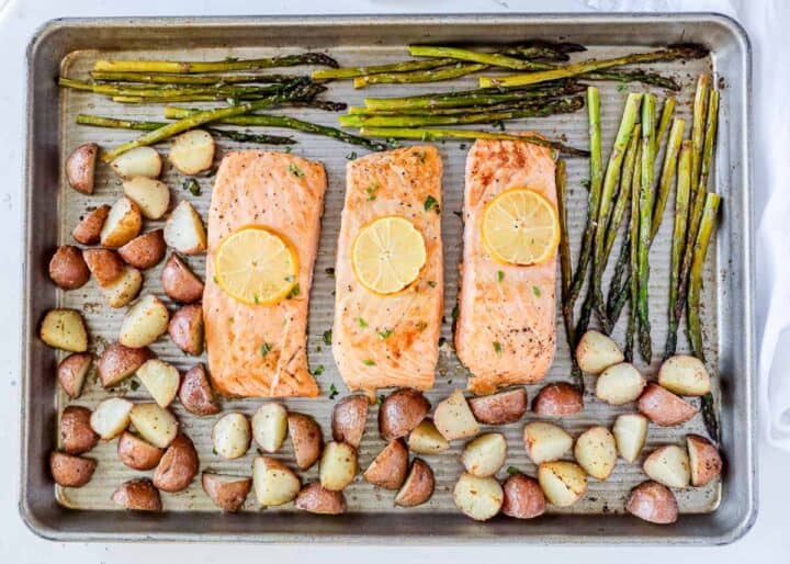 salmon, potatoes and asparagus on pan