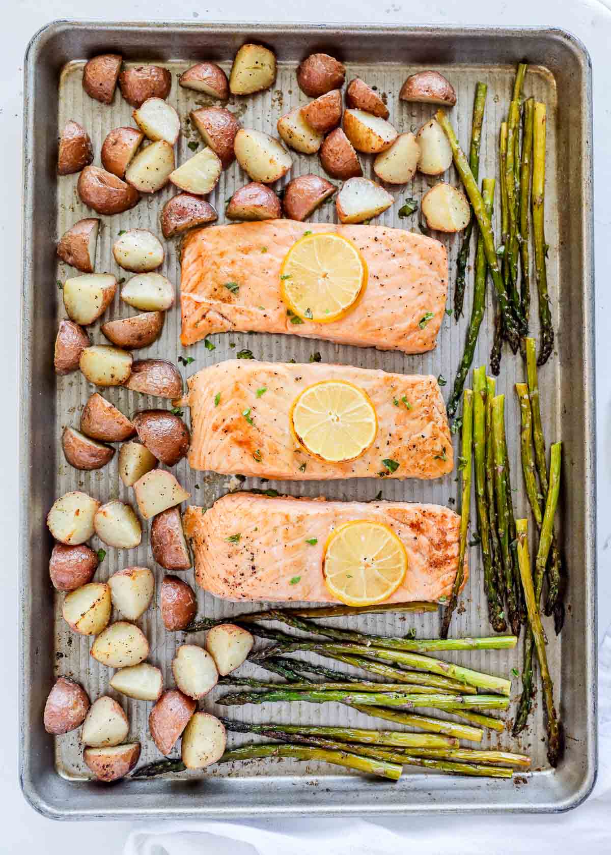 Salmon, potatoes and asparagus on sheet pan.