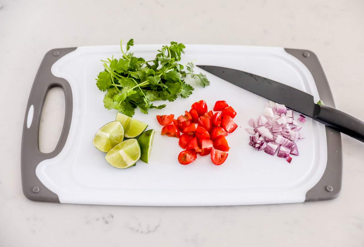 Sliced produce on cutting board.