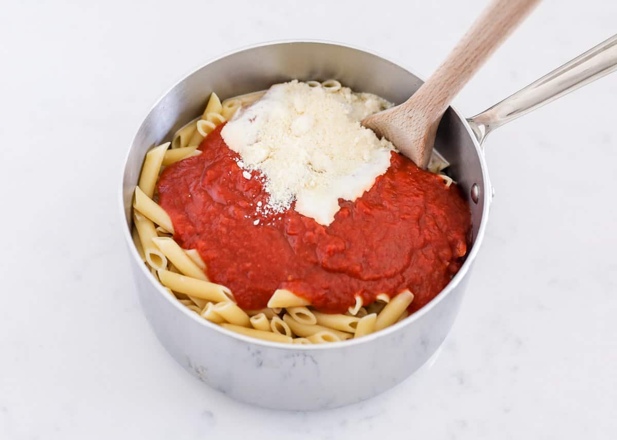 Noodles and sauce in metal pot.