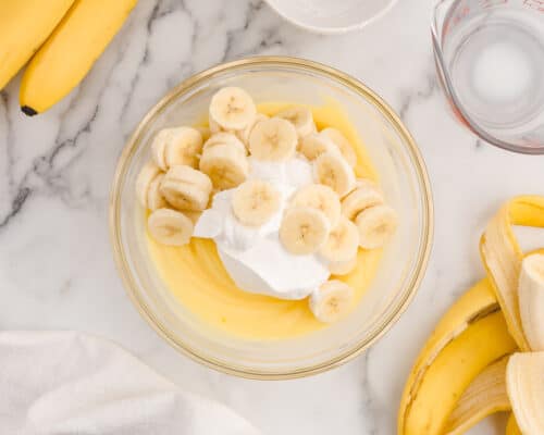 bananas and whipped cream in pudding