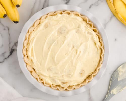 spreading banana cream pie mixture into pie crust
