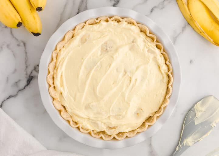spreading banana cream pie mixture into pie crust