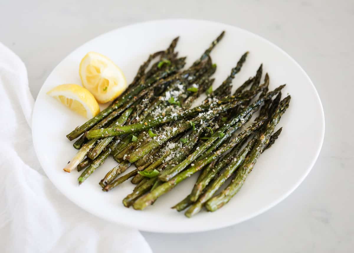 Grilled asparagus on white plate.