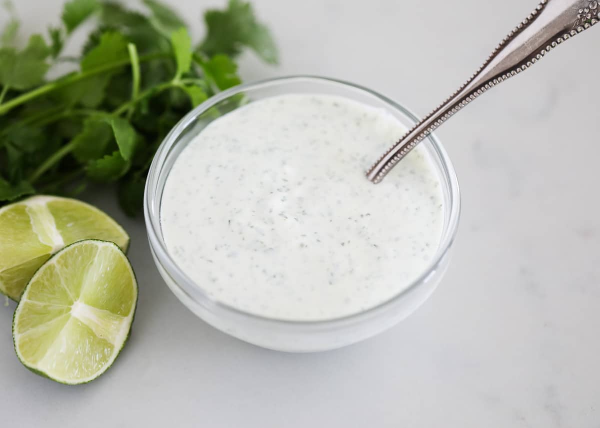 Cilantro lime crema in clear bowl.