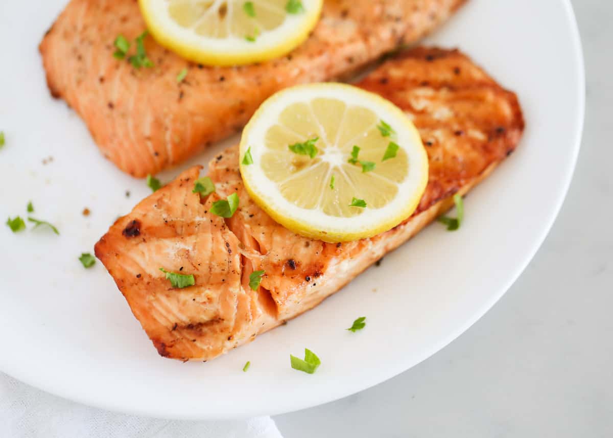 Grilled salmon on white plate.