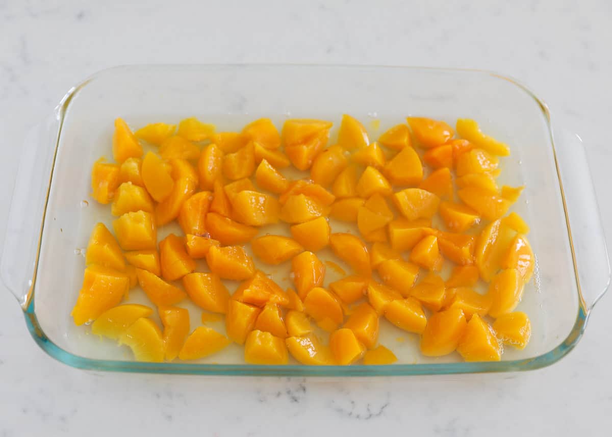 Peaches in clear pan.