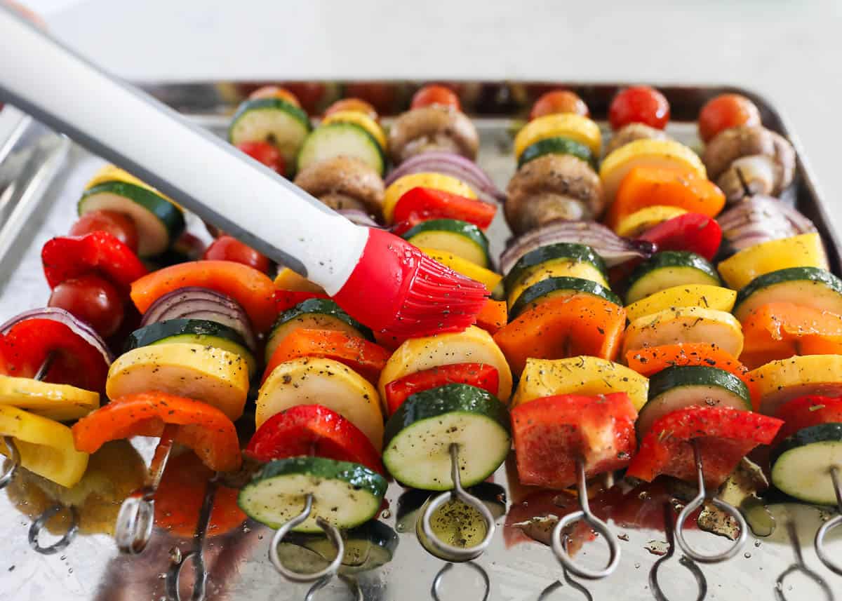 Vegetable skewers on pan.