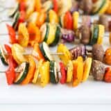 vegetable skewers on white platter