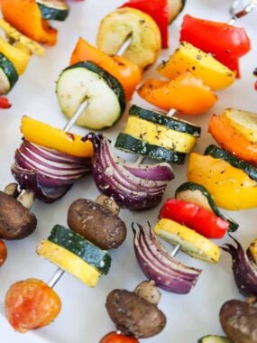vegetable skewers on white platter