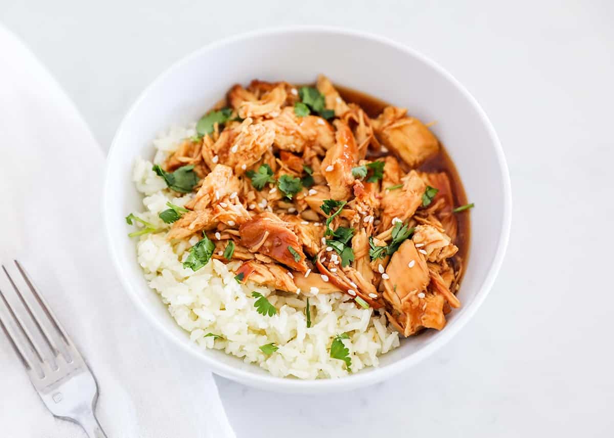 Teriyaki chicken and rice in white bowl.