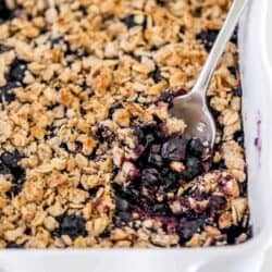 blueberry crisp in white baking dish