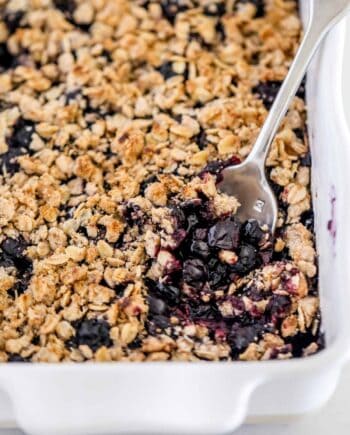 blueberry crisp in white baking dish