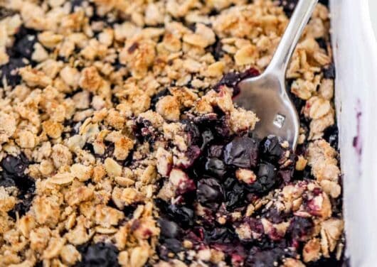 blueberry crisp in white baking dish