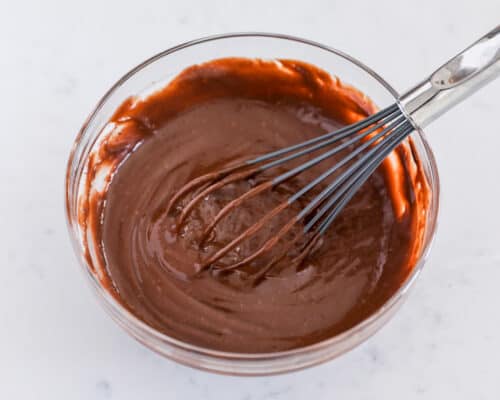 whisking chocolate pudding in bowl