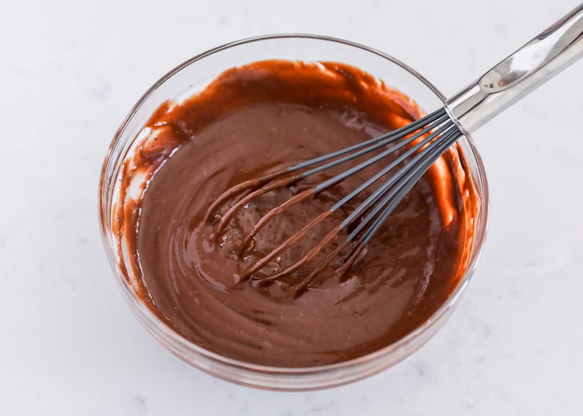 whisking chocolate pudding in bowl